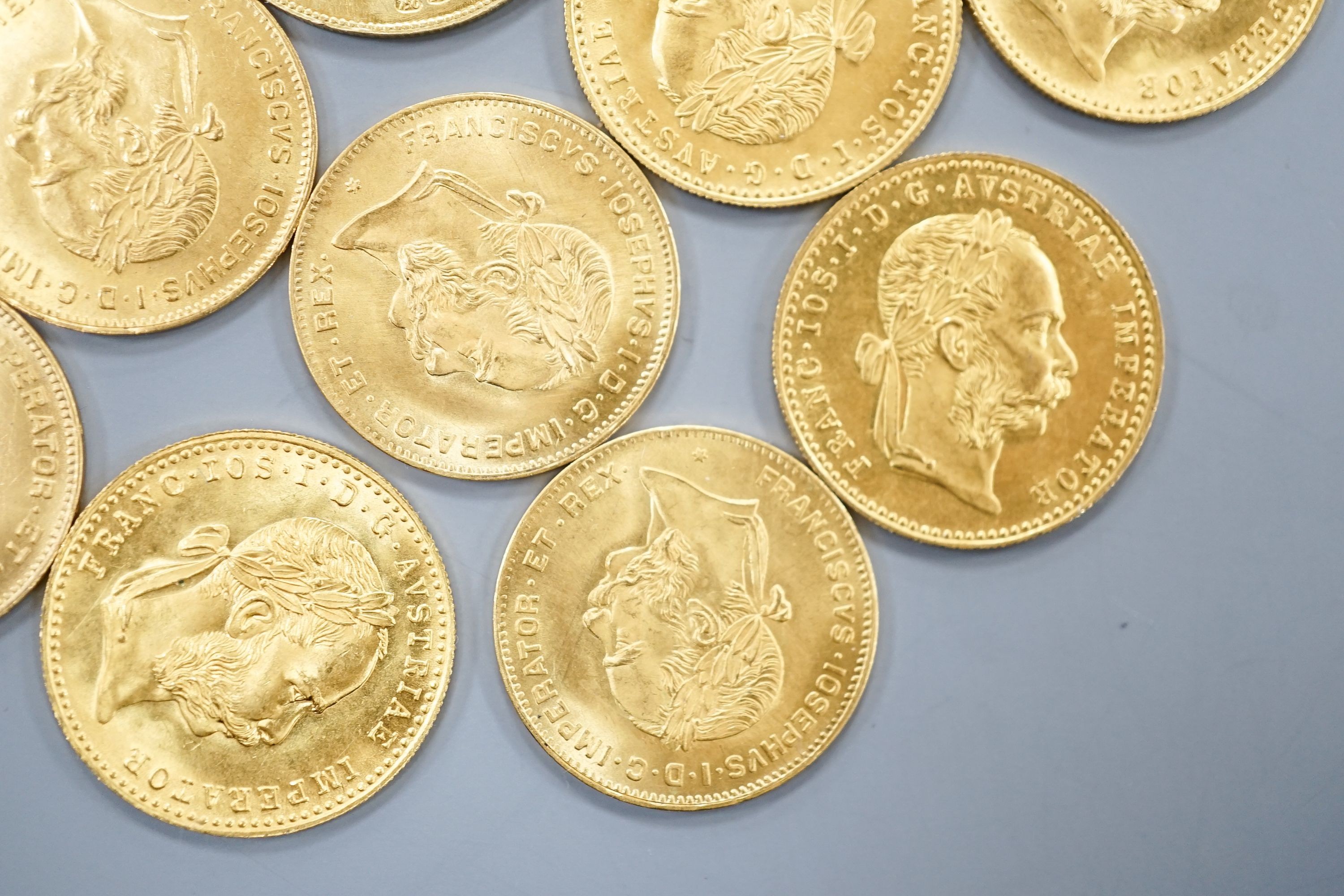 Ten Austrian gold Ducats (re-strikes) and an Italian 750 yellow metal 'I Star Lina de Amicizia'